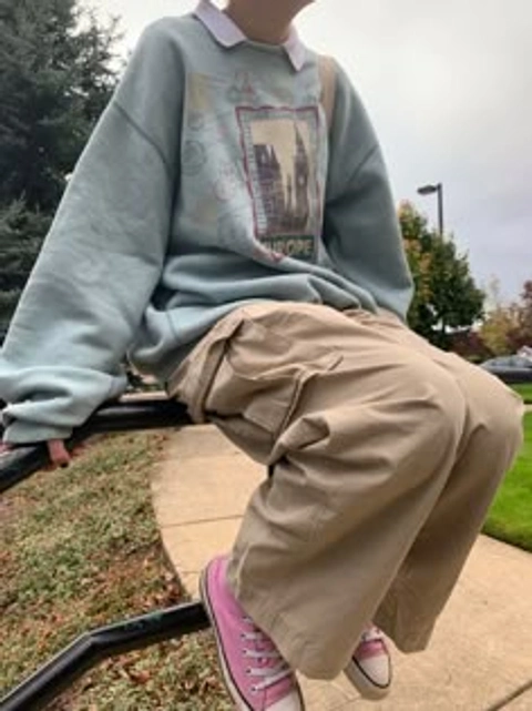 A mannequin sitting on top of a metal bench.