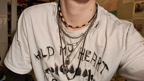 A man wearing a white shirt with a black and white design on it.