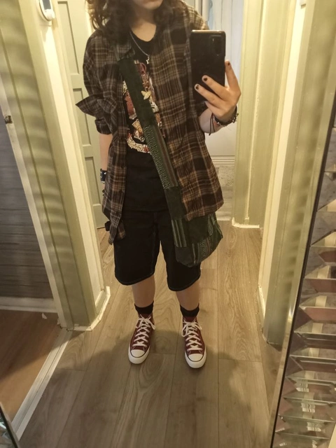 A woman taking a selfie in a mirror.