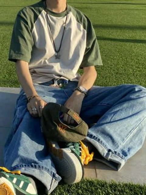 A man sitting on the ground with his legs crossed.
