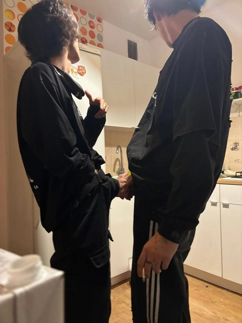 A man and a woman standing in front of a mirror.