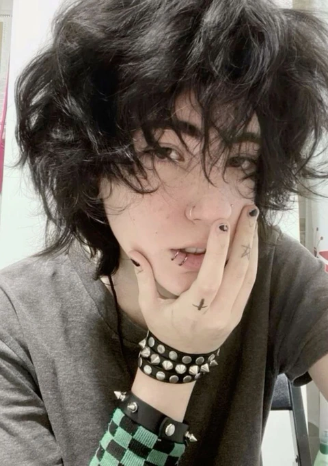 A woman with black hair and piercings on her face.