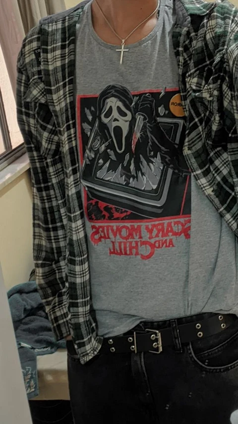 A mannequin wearing a shirt with a picture of a skeleton on it.