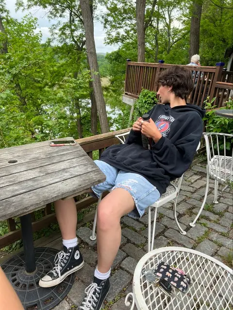 A man sitting at a table with a cup of coffee.