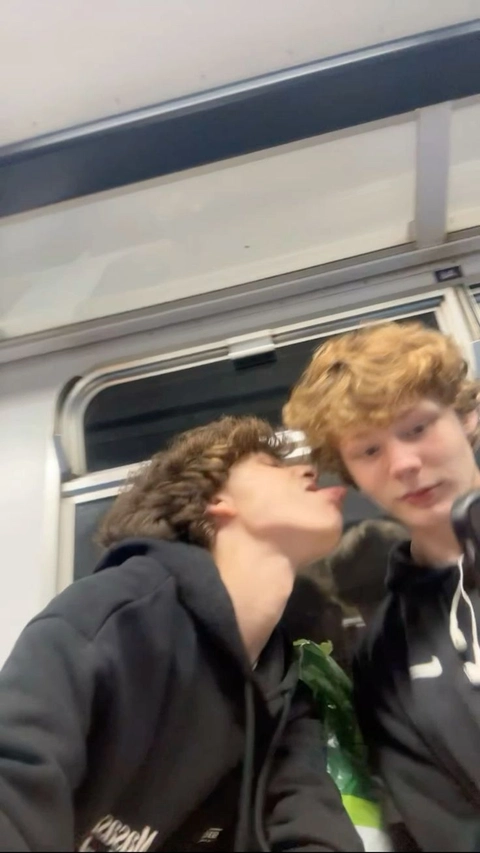 A group of young men standing next to each other on a train.