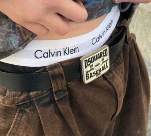 A close up of a person wearing a belt with a label on it.