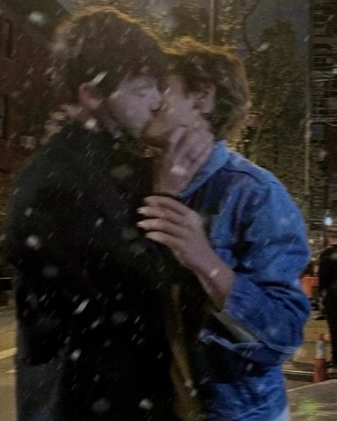 A couple of people that are standing in the snow.