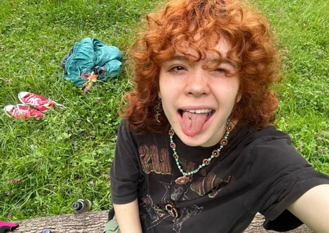 A woman with red hair sticking out her tongue.