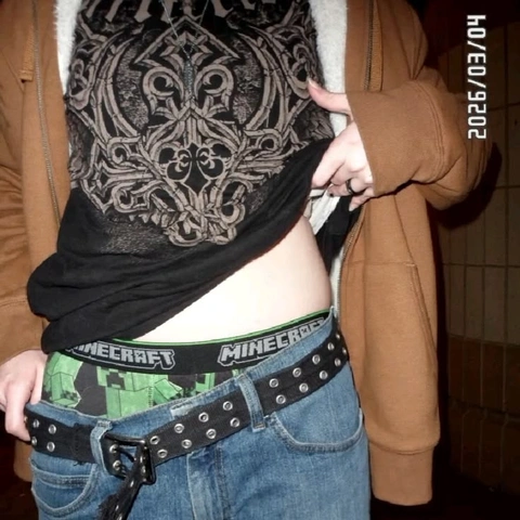 A woman wearing a black and white shirt and jeans.
