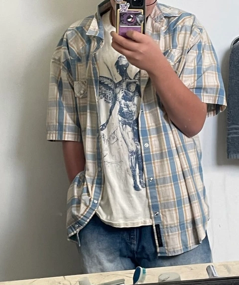 A man taking a picture of himself in a mirror.