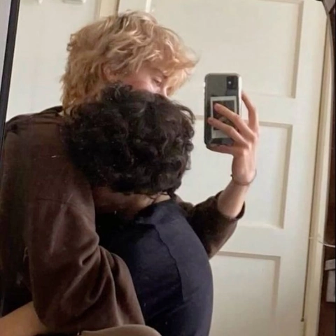 A woman taking a picture of herself in a mirror.