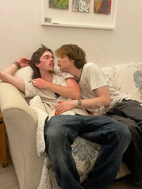 A group of young men sitting on top of a couch.