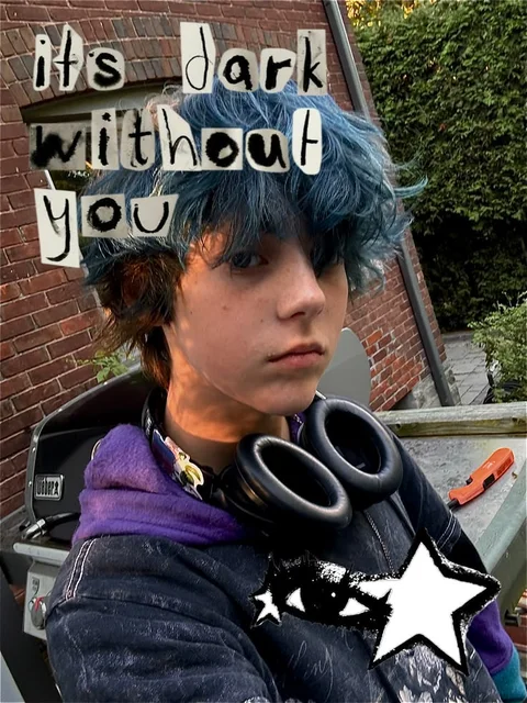 A young man with blue hair and a purple hoodie.
