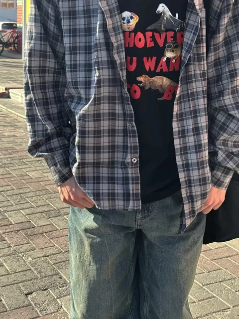 A man wearing a plaid shirt with a picture of a dog on it.