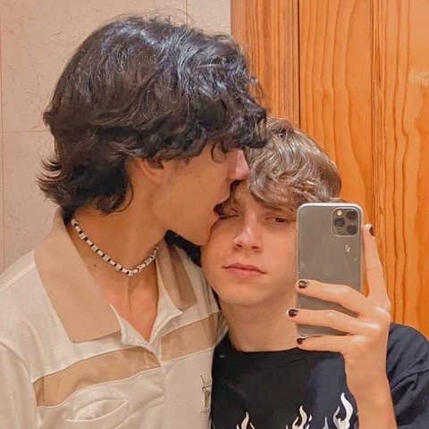 A man and a woman taking a selfie in a mirror.