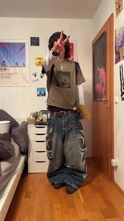 A man standing in a room with his hands up.