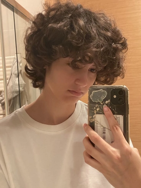 A woman taking a selfie in front of a mirror.