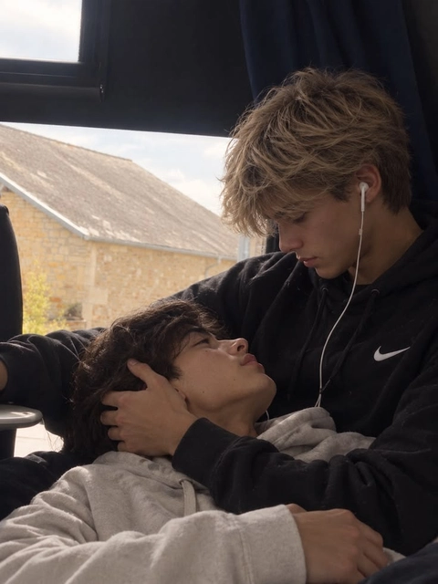 A group of young men laying on top of each other.