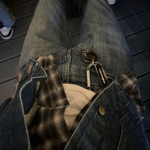 A pair of jeans with a pair of shoes in it.