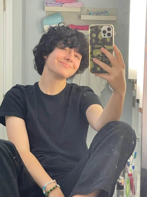 A young man taking a selfie in a mirror.