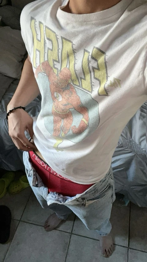 A man wearing a white shirt with a picture of a man on it.