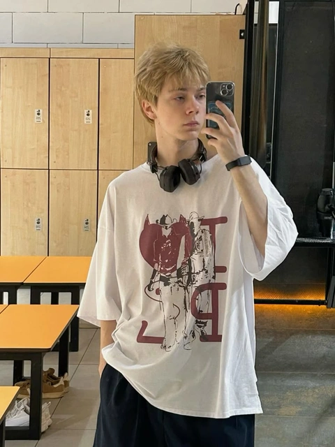 A young man taking a picture of himself in a mirror.