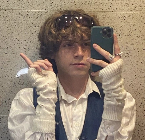 A man taking a selfie in a bathroom mirror.