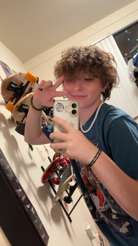 A young man taking a picture of himself in a mirror.