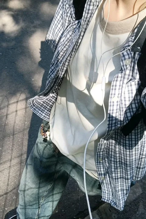 A mannequin wearing a white shirt and black pants.