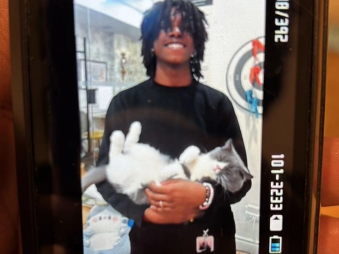 A man holding a cat in his arms.