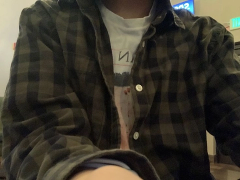 A person wearing a brown and black checkered jacket.