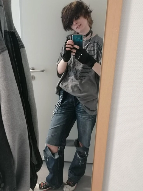 A woman taking a selfie in front of a mirror.