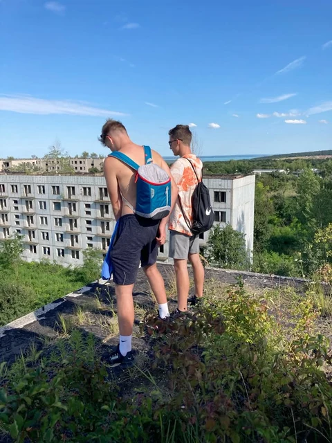 A group of people standing on top of a building.