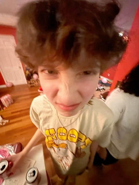 A young boy with a mohawk on his head.
