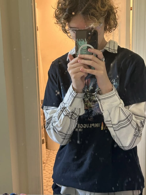 A woman taking a picture of herself in a mirror.
