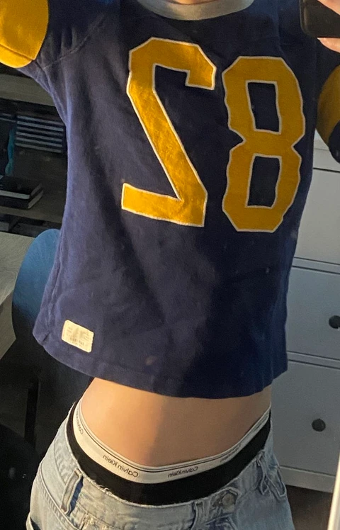 A woman wearing a football jersey with the number 28 on it.