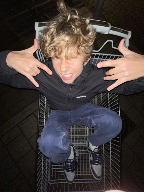A young boy sitting on top of a metal chair.