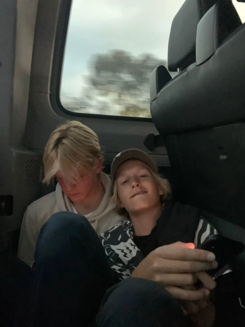 A group of people sitting on top of a bus.