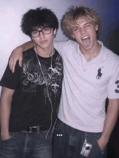 A couple of young men standing next to each other.