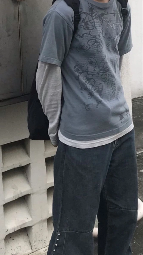 A mannequin wearing a gray shirt and black pants.