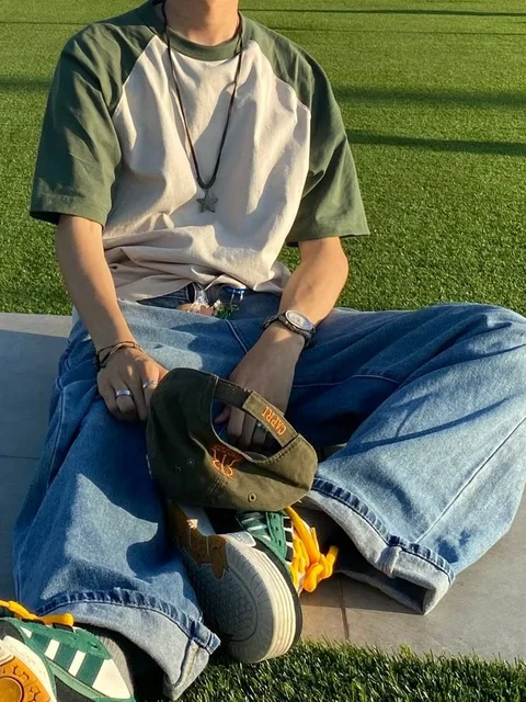 A man sitting on the ground with his feet up in the air.