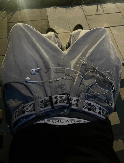 A pair of jeans with a pair of headphones attached to them.