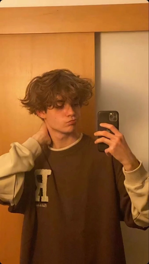 A man taking a picture of himself in a mirror.