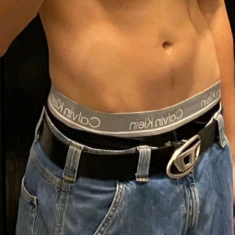 A close up of a man wearing a belt.