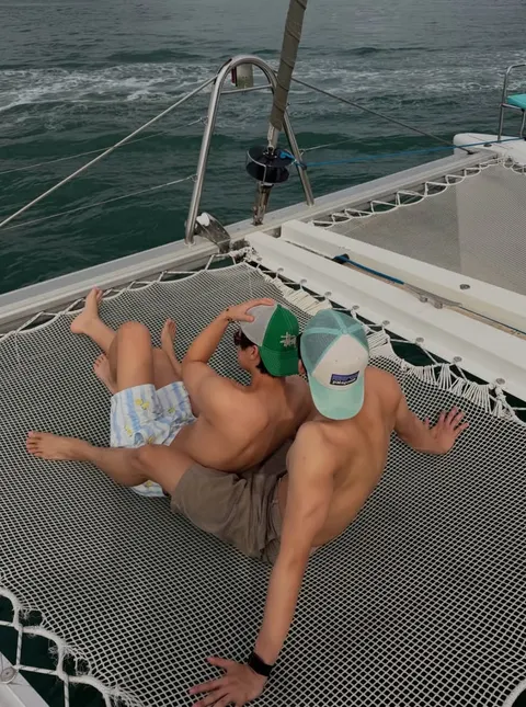 A group of men laying on top of a boat.