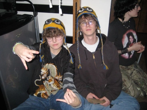 A group of young men sitting next to each other.