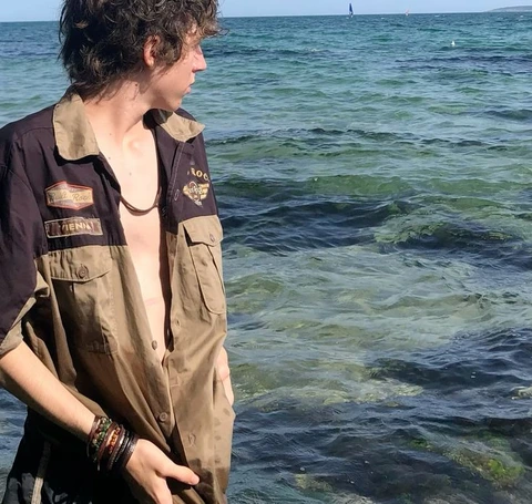 A man standing in the middle of a body of water.