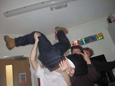 A group of people hanging upside down in a room.