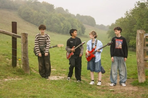 A group of young men standing next to each other in a field.