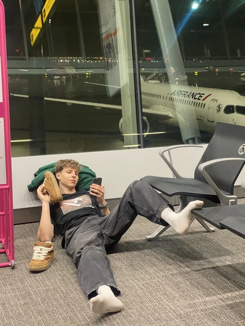 A man laying on the floor with his feet up in the air.